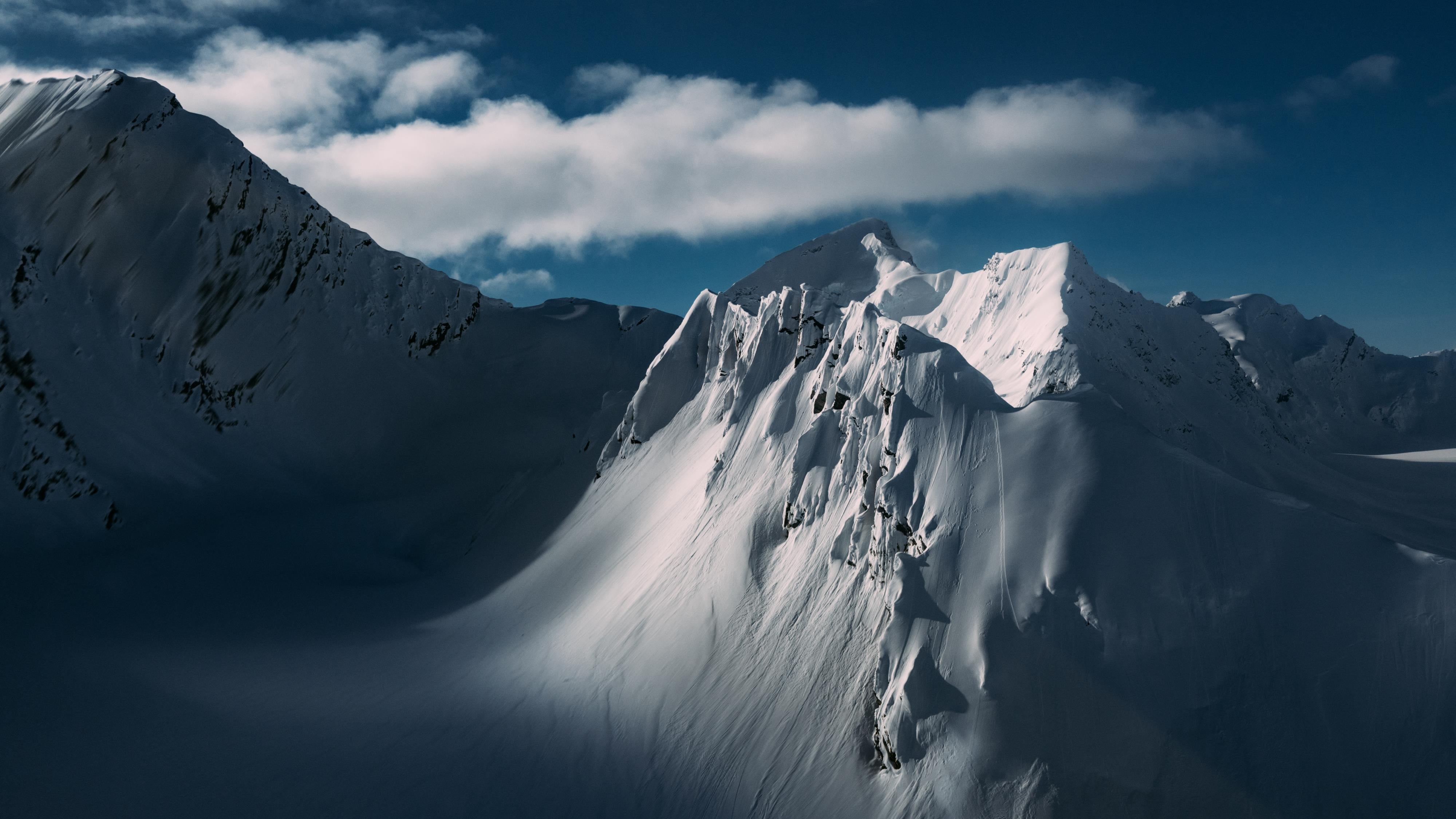 Snowy mountain landscape with a clear blue sky