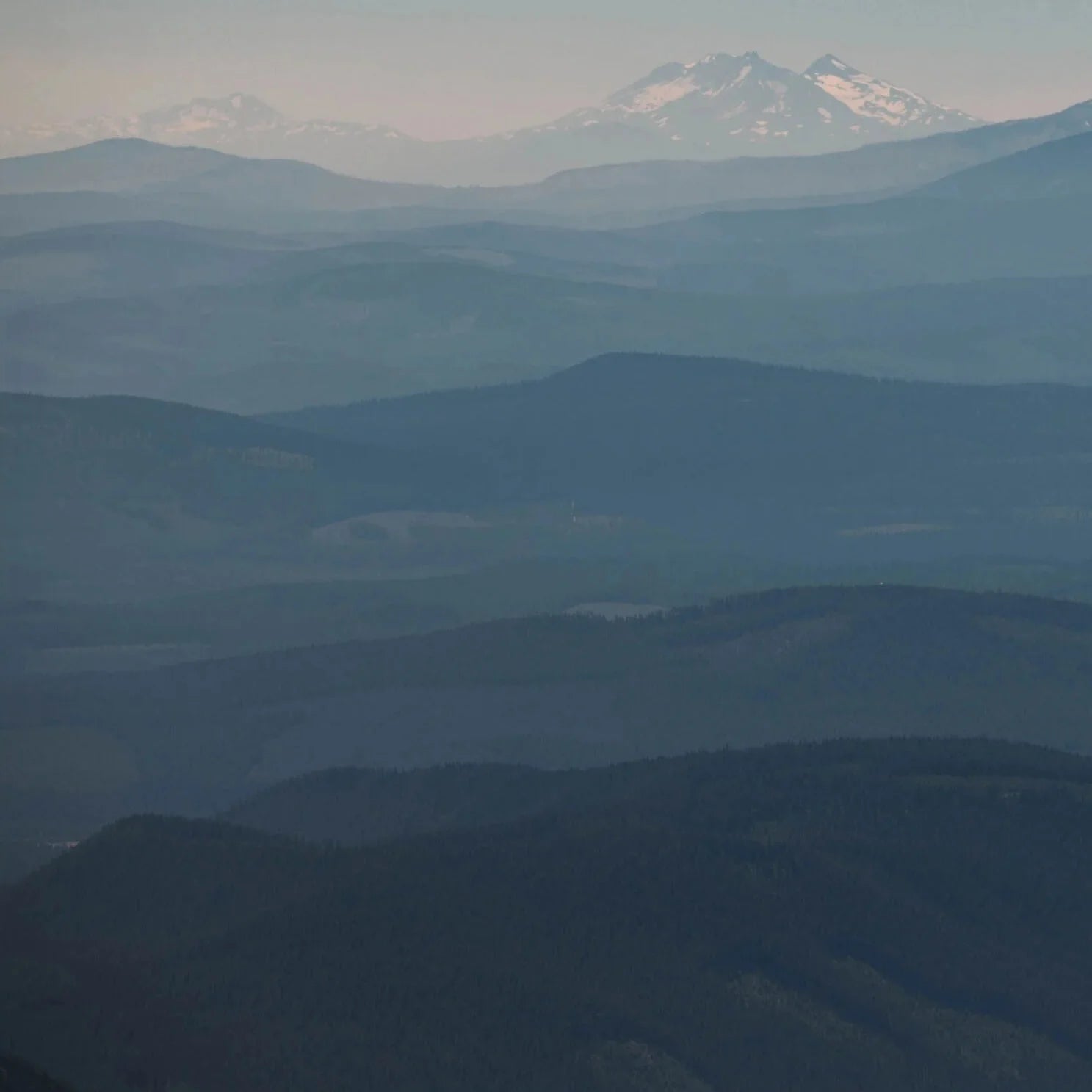 Hazy mountain range with a prominent peak in the distance