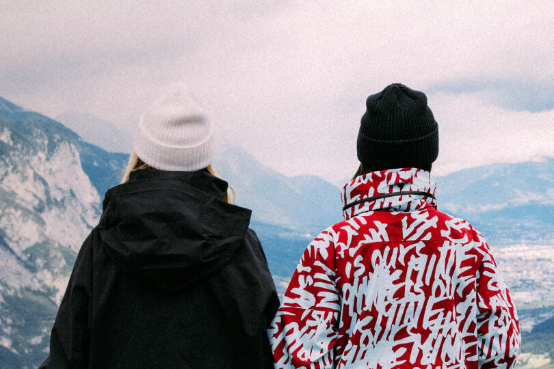 models wear Mine77 Outerwear and look out over mountains