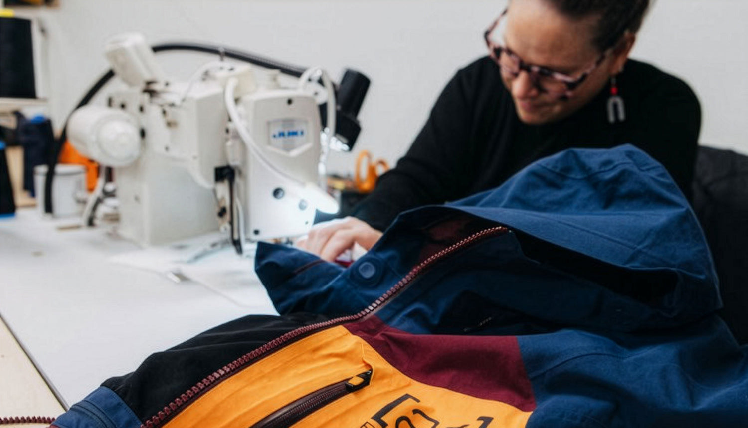 Person sewing a Burton [ak] Jacket