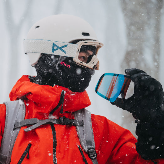A person modeling Magna-Tech goggles