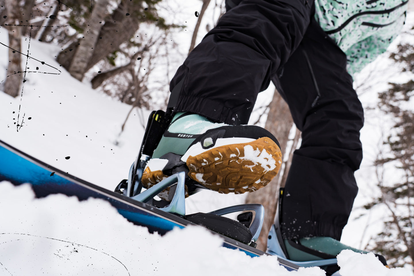 a person steps in to their step on bindings on snow
