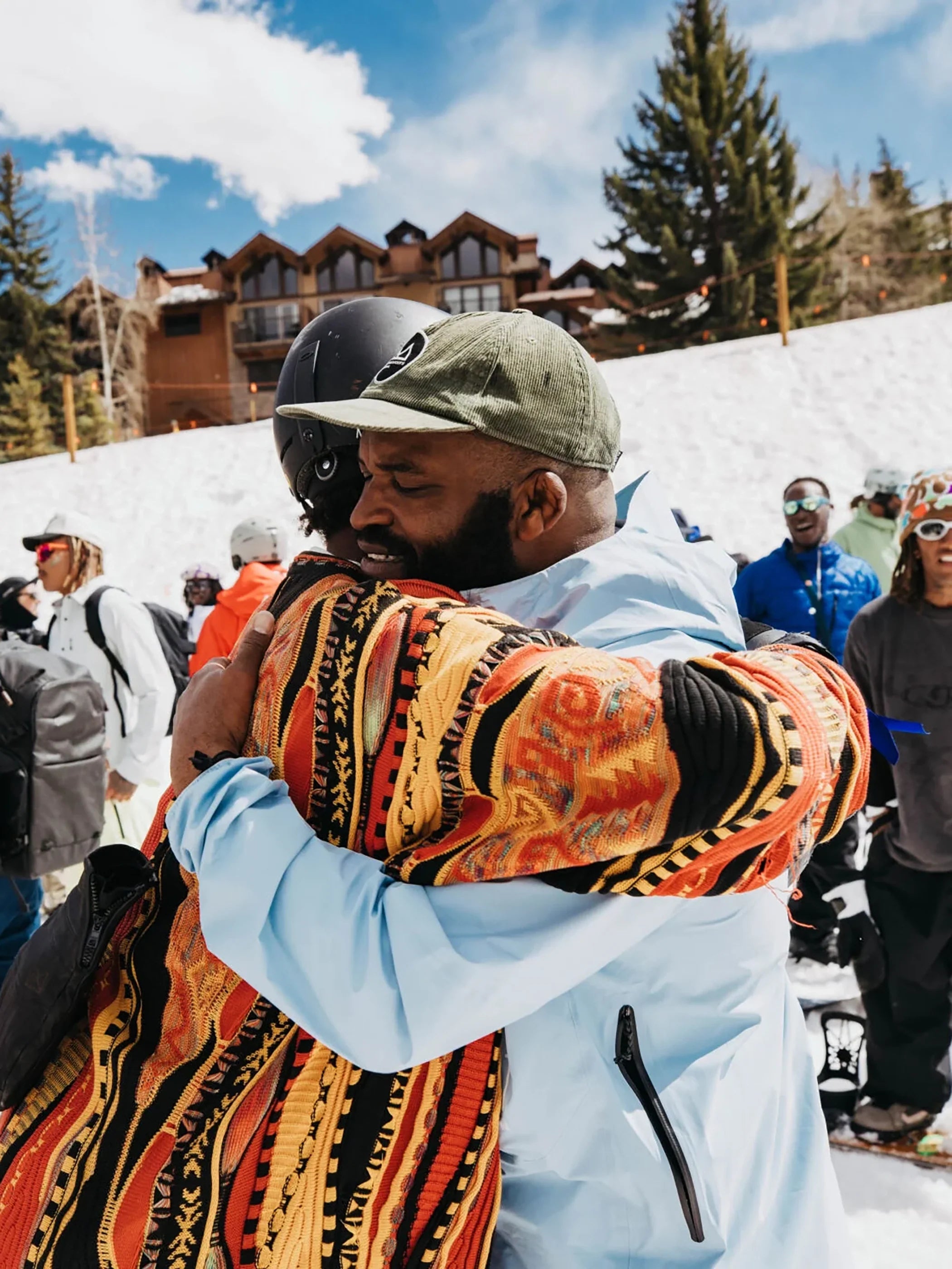 two BIPOC individuals embracing