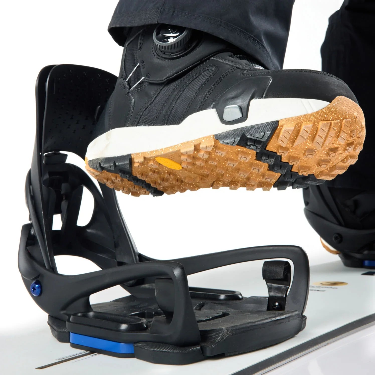Close-up of a snowboard binding with a boot on a white background