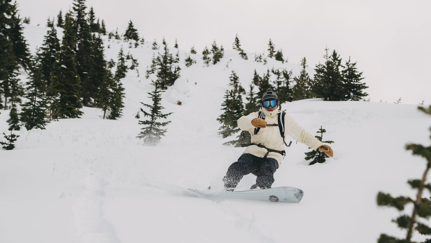 footage of Jake Burton Carpenter building and testing snowboards throughout the years