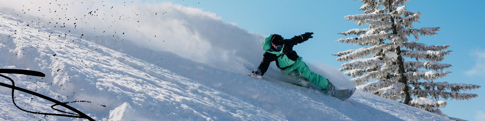 snowboarder slashes powder