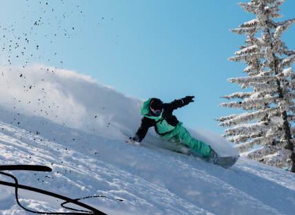 snowboarder slashes powder